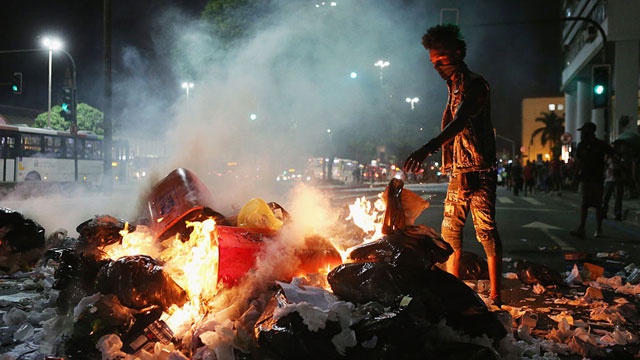 Protester sets fire to trash in Rio de Janeiro Brazil