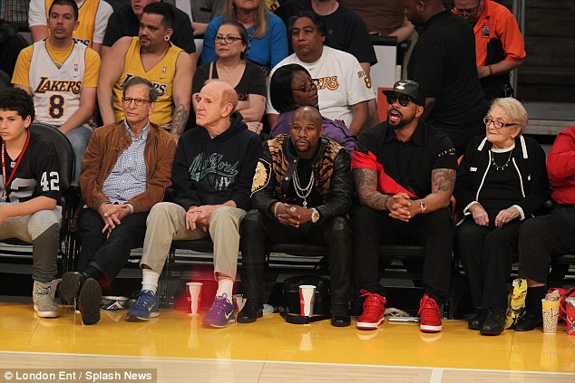 Mayweather enjoys the action with courtside seats as the hosts stunned the defending champions