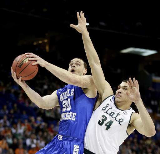 Middle Tennessee's Reggie Upshaw puts up a shot under pressure from Michigan State's Gavin Schilling during the second half of a first-round men's college basketball game in the NCAA Tournament Friday