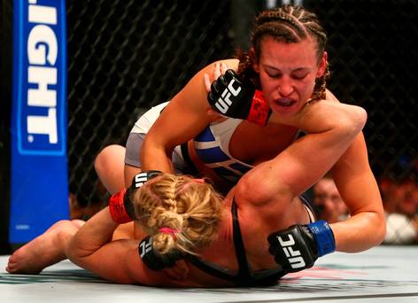 Miesha Tate pins Holly Holm to the mat during UFC 196 at MGM Grand Garden Arena. Mandatory Credit Mark J. Rebilas-USA TODAY Sports