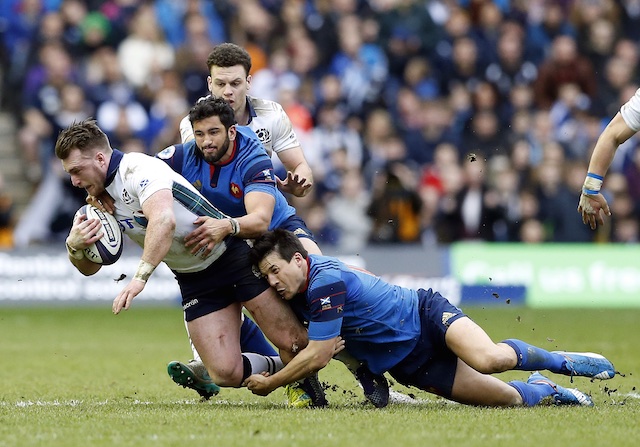 Scotland's Stuart Hogg left is tackled by France's Francois Trinh-Duc right and Maxime Mermoz during their Six Nations rugby union international match at Murrayfield stadium Edinburgh Scotland Sunday