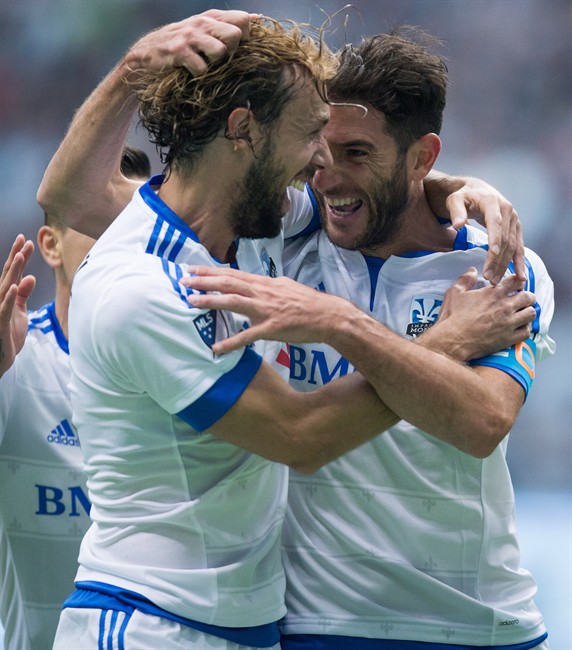 Montreal Impact's Marco Donadel left of Italy and Ignacio Piatti of Argentina celebrate Piatti's goal against the Vancouver Whitecaps during first half MLS soccer action in Vancouver on Sunday Mar. 6 2016. THE CANADIAN PRESS  Darryl Dyck