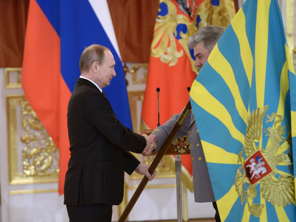 Russian President Vladimir Putin presents a banner to Russian air-space forces in Moscow