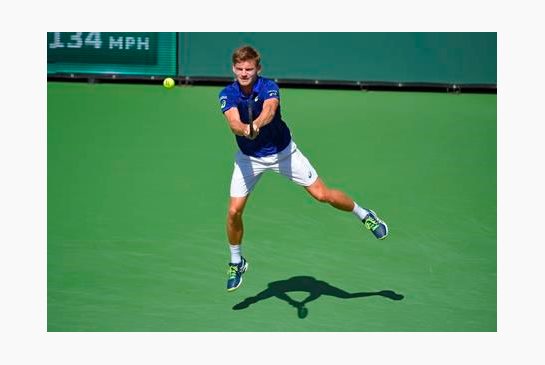 David Goffin of Belgium returns to Milos Raonic of Canada during their semifinal match at the BNP Paribas Open tennis tournament Saturday