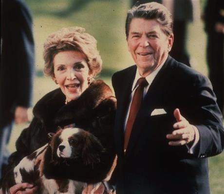 Nancy Reagan holding the Reagans&#039 pet Rex a King Charles spaniel as she and President Reagan walk on the White House South lawn. The former first lady has died at 94 The Associated Press confi