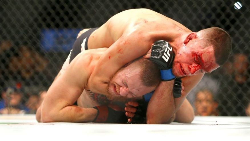 LAS VEGAS NV- MARCH 5 Nate Diaz applies a choke hold to win by submission against Conor Mc Gregor during UFC 196 at the MGM Grand Garden Arena