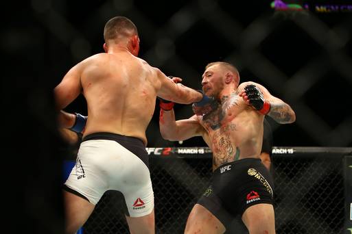 Nate Diaz lands a right hand on Conor McGregor