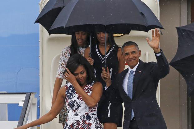 US President Barack Obama, his wife Michelle and their daughters Malia and Sasha exit Air Force One as they arrive at Havana’s international airport for a three-day trip in Havana on Sunday