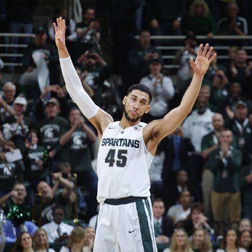 Denzel Valentine acknowledges the crowd as he comes out of the game in the closing minute of an NCAA college basketball game against Ohio State Saturday