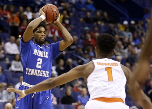 Middle Tennessee's Perrin Buford left looks to pass as Syracuse's Franklin Howard watches during the first half in a second-round men's college basketball game in the NCAA Tournament Sunday