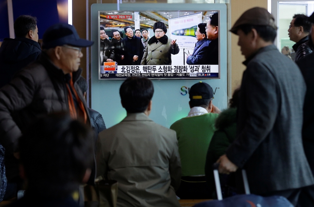 People watch a TV news program showing North Korean leader Kim Jong Un with superimposed letters that read'North Korea has made nuclear warheads small enough to fit on ballistic missiles at Seoul Railway Station in Seoul South Korea Wednesday March