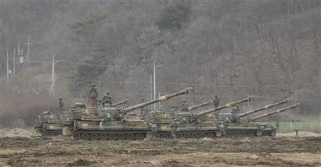 South Korean army soldiers stand on their K-55 self-propelled howitzers during an annual exercise in Paju near the border with North Korea