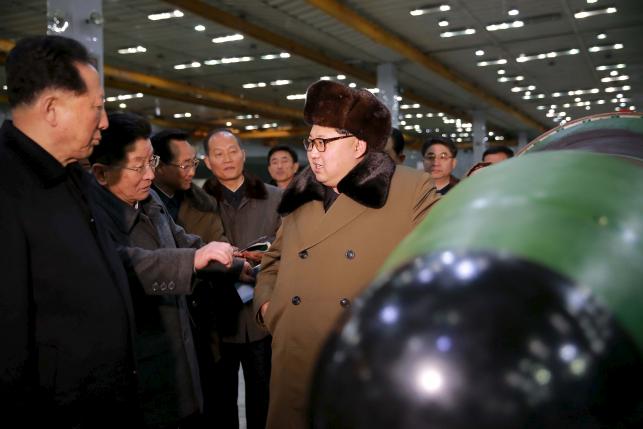 North Korean leader Kim Jong Un meets scientists and technicians in the field of researches into nuclear weapons in this undated