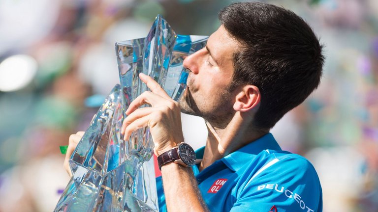 Novak Djokovic kisses the trophy after defeating Milos Raonic at Indian Wells