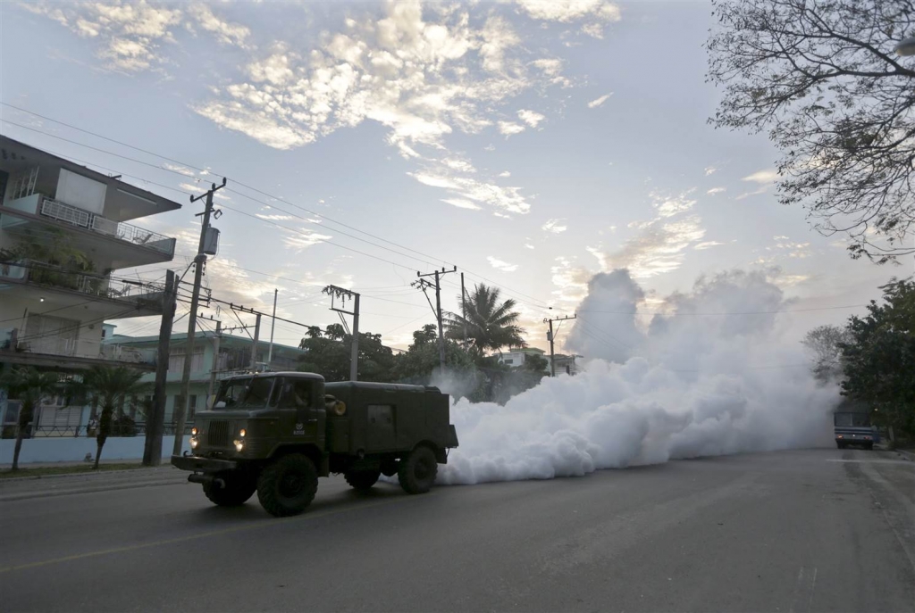 Image A military truck carries out fumigation in a neighborhood to stop the breeding of the dengue mosquito in Havana