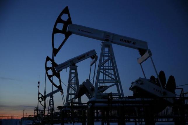 Pump jacks are seen at the Lukoil company owned Imilorskoye oil field as the sun sets outside the West Siberian city of Kogalym Russia