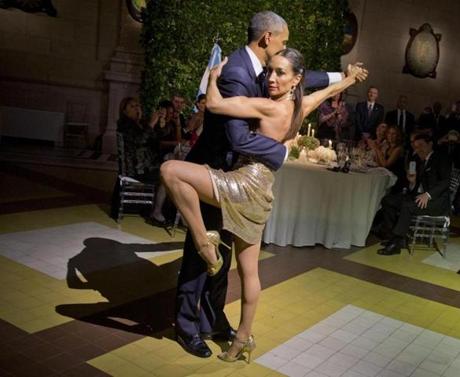 President Barack Obama with does the tango with a dancer during the State Dinner at the Centro Cultural Kirchner Wednesday