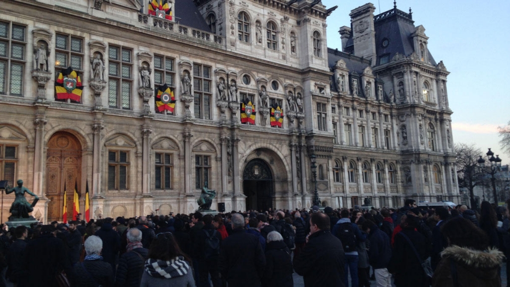 Parisians observe a moment of silence in front of City Hall in honor of the Belgian victims and their own.   Emma Jacobs