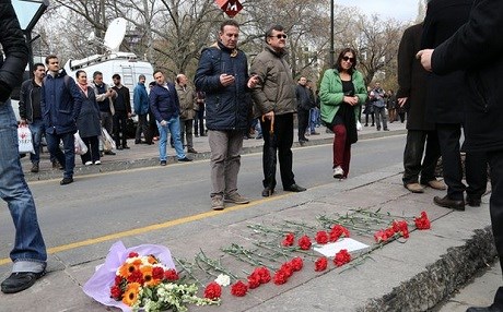 People gather at the site of Sunday’s bombing in Ankara Turkey