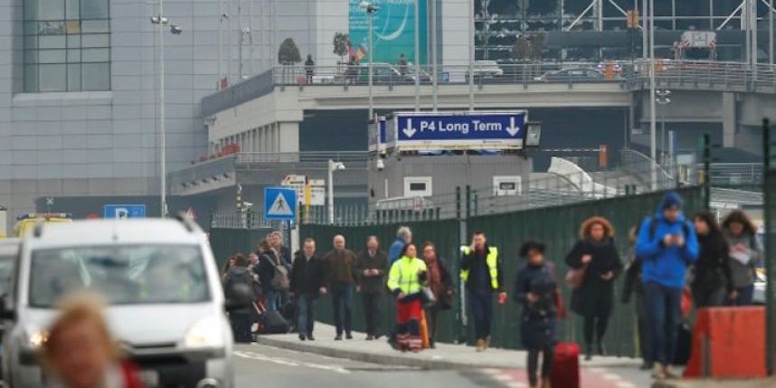 People leave the scene of explosions at Zaventem airport near Brussels Belgium