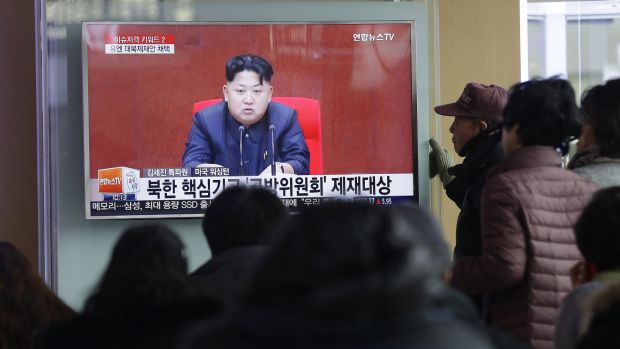 People watch a TV news program showing North Korean leader Kim Jong-un at Seoul Railway Station in Seoul on Thursday