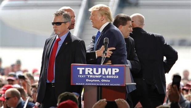 Security personnel surround Republican presidential candidate Donald Trump during a rally in Vandalia Ohio on Saturday