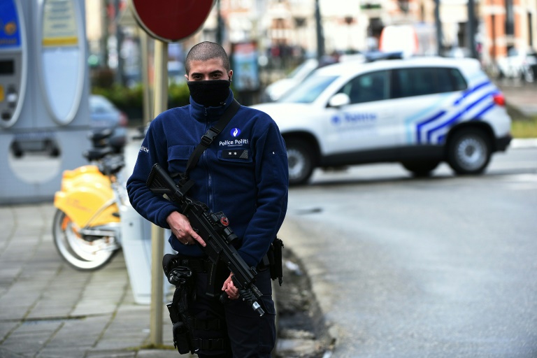 AFP  Patrik StollarzA police officer patrols near a train after it was evacuated during an anti-terrorist operation in the Schaerbeek- Schaarbeel district in Brussels