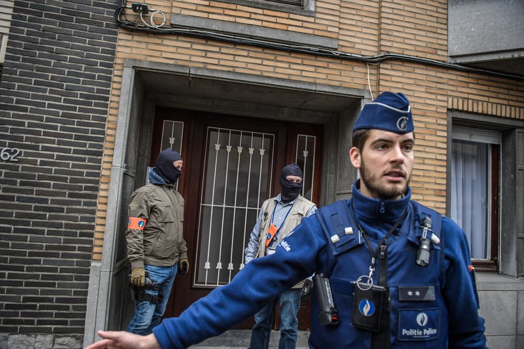 Police search a house in Brussels.     EPA  Christophe Petit Tisson