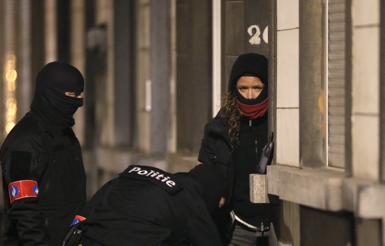 Police secure the entrance to a building in Schaerbeek during operations following the bomb attacks in Brussels. REUTERS  Christian Hartmann