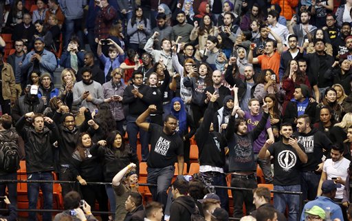 Protesters against Republican presidential candidate Donald Trump chant after it was announced that a rally for Trump was canceled due to security concerns on the campus of the University of Illinois-Chicago Friday