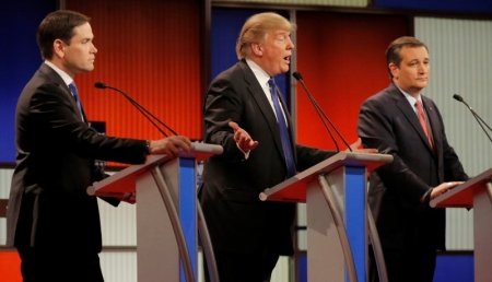 Republican U.S. presidential candidate Donald Trump gestures between rival candidates Marco Rubio and Ted Cruz at the U.S. Republican presidential candidates debate in Detroit Michigan