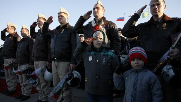 Russian air force pilots salute upon their arrival from Syria at an airbase in the southern Russia's Krasnodar region