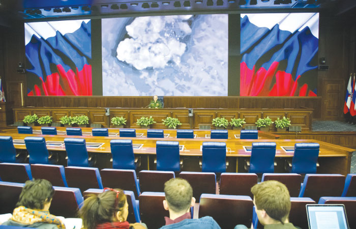 Lt. Gen. Sergei Rudskoi of the Russian Military General Staff background center speaks to the media in Moscow while the screen shows an aerial image of an air strike during the attack of Russian warplanes in Syria. Russia's Defense Ministry says its war