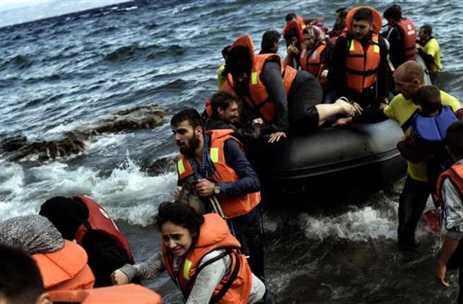 Refugees land on the Greek island of Lesbos after crossing the Aegean sea from Turkey