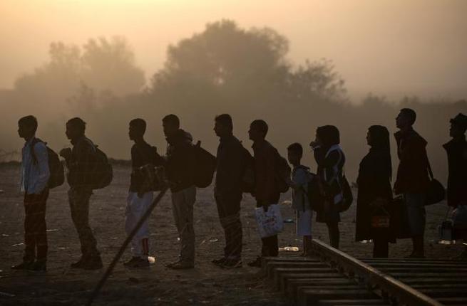 Refugees queue to cross the Greek Macedonian border near Gevgelija