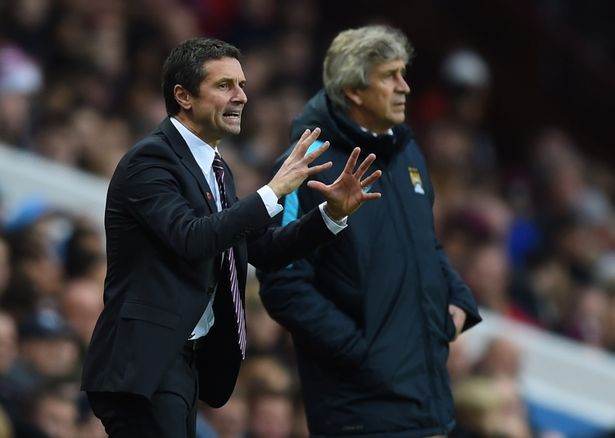 Remi Garde Manager of Aston Villa directs his players as Manuel Pellegrini the manager of Manchester City looks