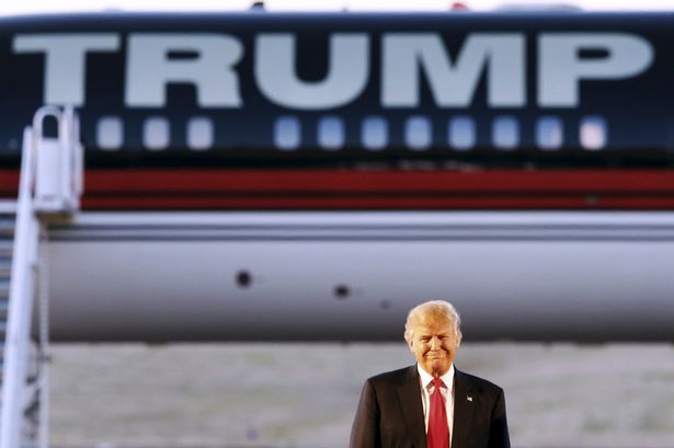 Plane sailing Donald Trump stands in front of his private jet while attending a rally in Tennessee