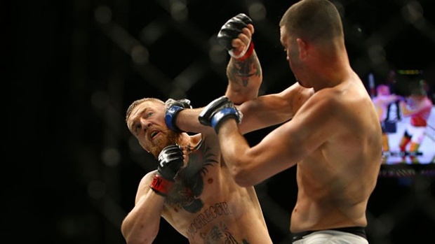 Nate Diaz punches Conor Mc Gregor at UFC 196