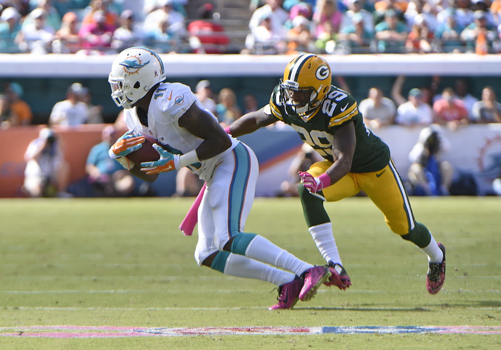 12 October 2014 Green Bay Packers Cornerback Casey Hayward  tackles Miami Dolphins Wide Receiver Mike Wallace  in Green Bay's 27-24 victory at Sun Life Stadium Miami Florida