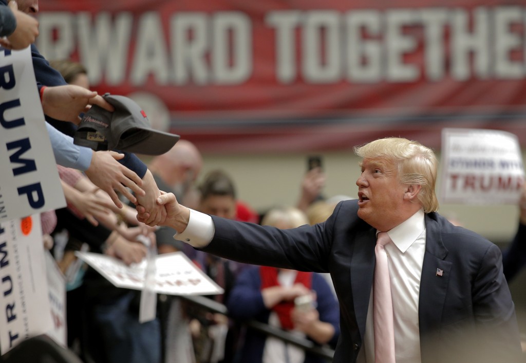 Republican presidential candidate Donald Trump shakes hands with supporters following a campaign event in Radford Virginia