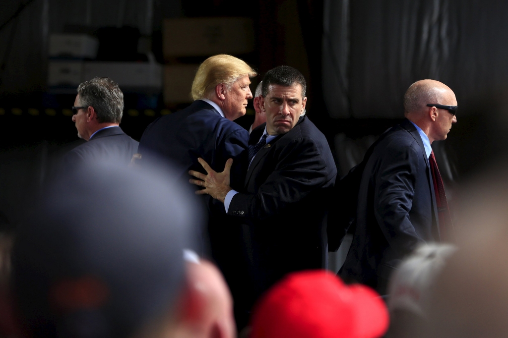 Secret Service agents surround Donald Trump during a disturbance at a rally in Dayton