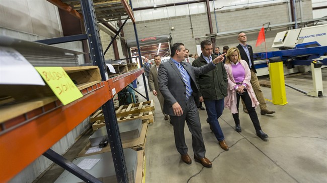 Republican presidential candidate Sen. Ted Cruz R-Texas and Troy Berg left president of Dane Manufacturing along with Heidi Cruz walk through the production plant at a campaign stop Thursday