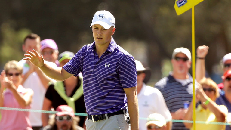 Spieth acknowledges the crowd after chipping in at the fifth