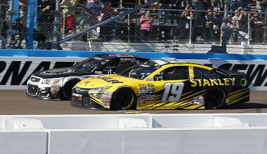 Carl Edwards collides with winner Kevin Harvick at the finish line during the NASCAR Sprint Cup Series race at Phoenix International Raceway