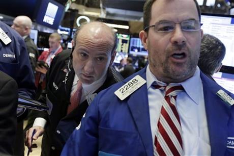 Trader Andrew Silverman left and specialist Michael Mc Donnell work on the floor of the New York Stock Exchange Tuesday Feb. 23 2016. Stocks are opening slightly lower on Wall Street as the market gives back some of a big gain from the day before. (AP