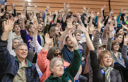 Supporters of Democratic presidential candidate Bernie Sanders vote for a caucus chairman at a Democratic caucus at Bryan High School in Bellevue Neb. Saturday