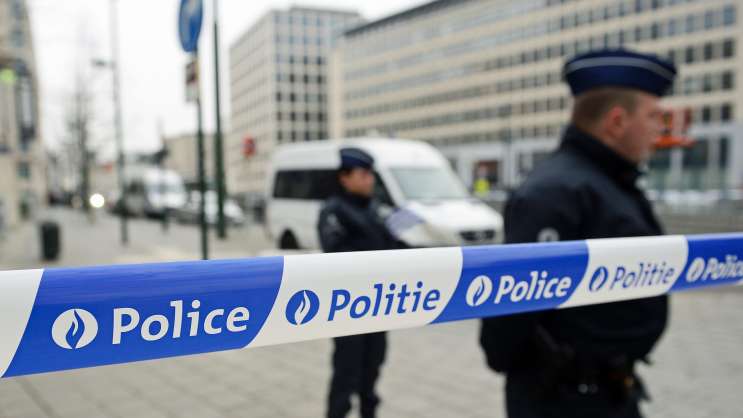 Policemen patrol outside the council chamber of Brussels on Thursday during ongoing investigations into the Paris and Brussels terror attacks. More than 30 people have been identified as being involved in a network behind the Paris attacks on November 13