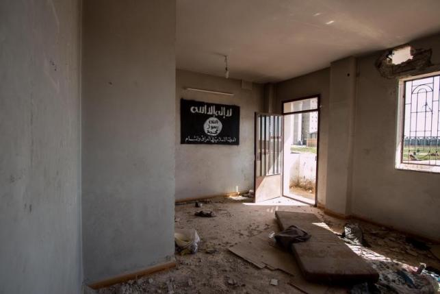 An ISIS flag hangs on the wall of an abandoned building in Tel Hamis in Hasaka countryside after the Kurdish People's Protection Units took control of the area