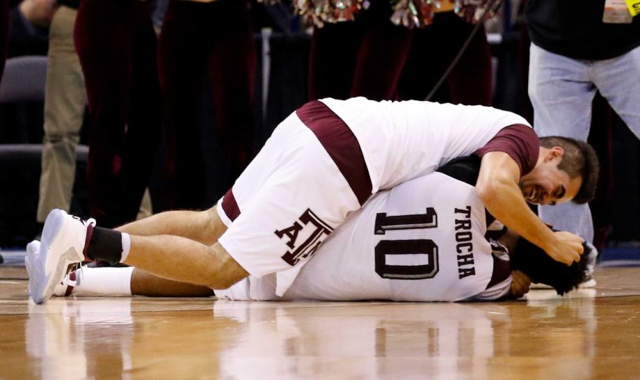 Texas A&M guard Juan Aparicio top and Texas A&M center Tonny Trocha-Morelos bottom celebrate after defeating Northern Iowa in double overtime in the second half during a second-round men's college basketball game in the NCAA Tournament in Oklahoma Ci