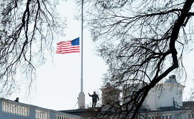 The US flag flies at half-staff on the White House in Washington